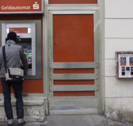 Man at atm and gumball dispenser